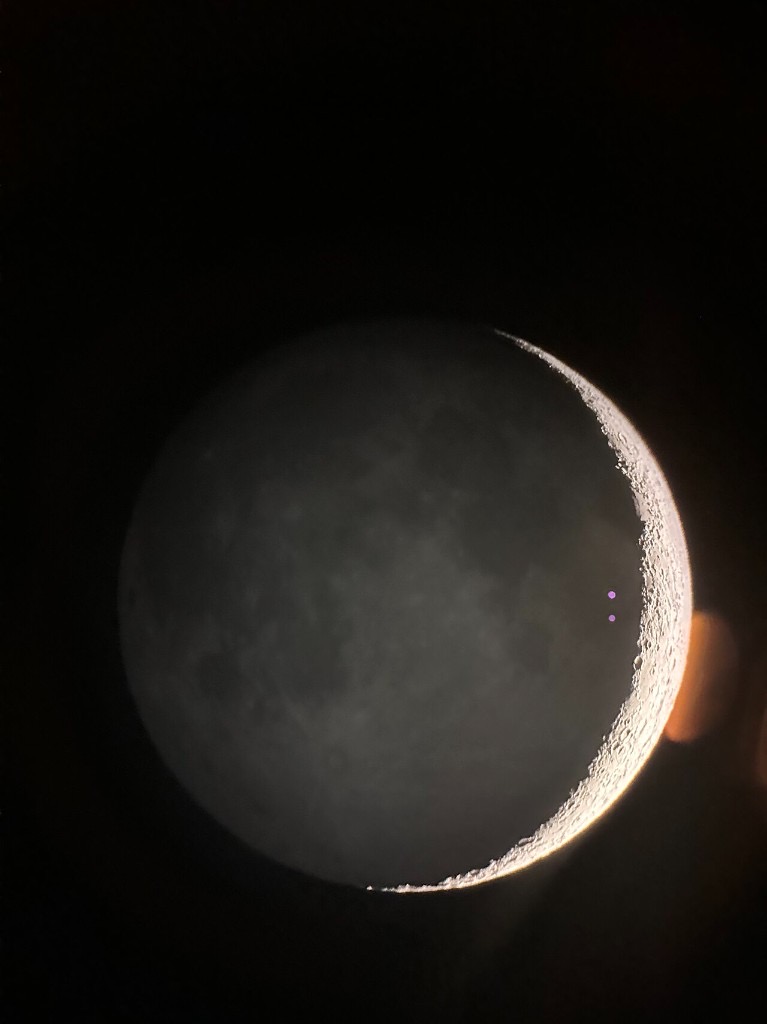 A waxing crescent moon with earthshine
